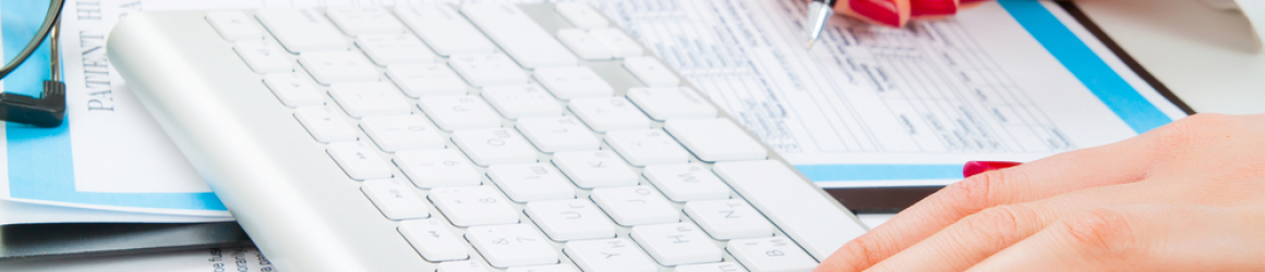 Doctor writing prescription and work with keyboard. Selective focus