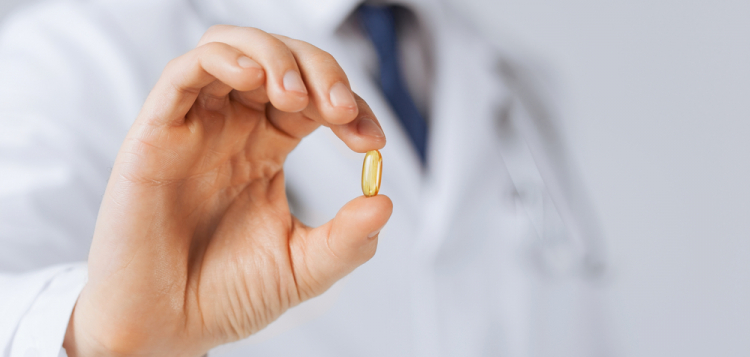 picture of doctor hand showing one capsule picture of doctor hand showing one capsule